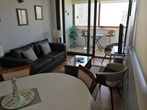 a living room with a couch and a table at Rent apartment Viña del Mar in Viña del Mar