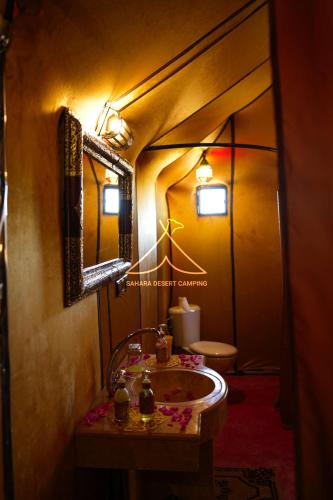 a bathroom with a sink and a toilet at Sahara Desert Camping - Luxury Desert Camp Merzouga in Erfoud