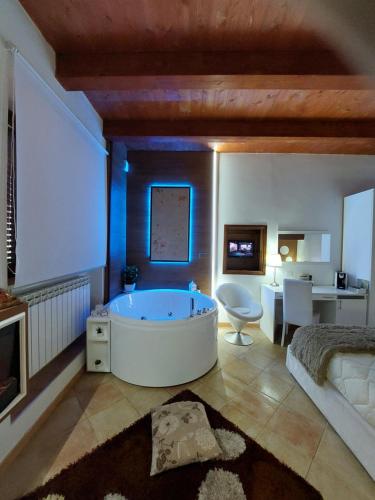 a large bathroom with a tub and a bedroom at Del Cavaliere in Castrovillari