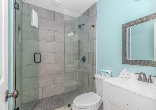 a bathroom with a shower and a toilet and a sink at 125 Atlantic Avenue Unit H - Pet Friendly! Walk To The Beach and Pier!1BR -1BA - Sleeps 4 guests! in Myrtle Beach