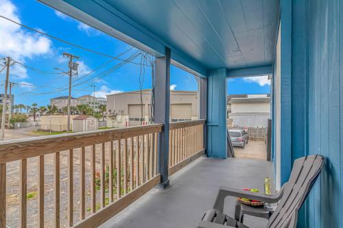 a porch with a chair and a view of a street at 125 Atlantic Avenue Unit G1 - Pet Friendly! Walk To The Beach and Pier! 2BR -1BA - Sleeps 6 guests! in Myrtle Beach