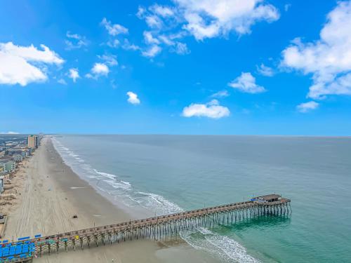 an aerial view of the beach with a pier at 125 Atlantic Avenue Unit G1 - Pet Friendly! Walk To The Beach and Pier! 2BR -1BA - Sleeps 6 guests! in Myrtle Beach