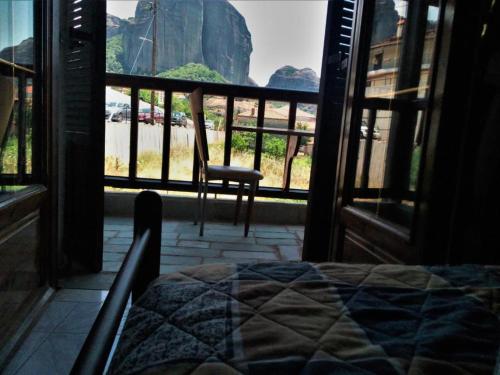 a bedroom with a view of a mountain from a window at Kostis Hause in Kastrákion