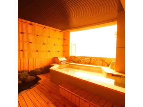 Hotel Mikawa Kaiyoukaku - Vacation STAY 90625v في غاماغوري: حوض استحمام في غرفة مع نافذة كبيرة