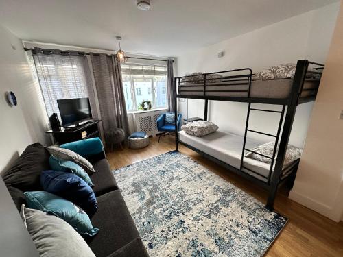 a living room with two bunk beds and a couch at 1 stop to London Bridge in London