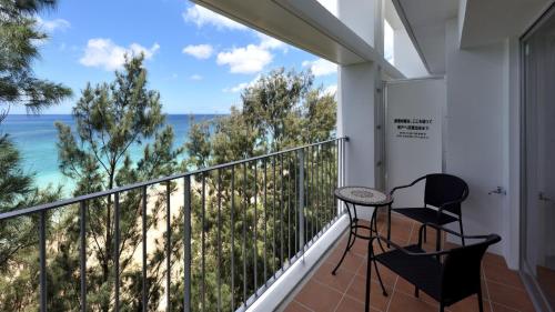 a balcony with chairs and a view of the ocean at On the Beach Lue - Vacation STAY 91578v in Sesoko