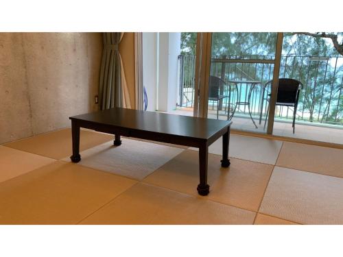 a coffee table sitting on a floor in a room at On the Beach Lue - Vacation STAY 91578v in Sesoko
