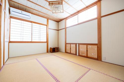 an empty room with two large windows at Yuan - Vacation STAY 01317v in Matsue