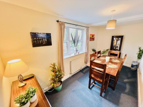 a dining room with a table and a window at Conservation Area - between Bristol and Bath, both 9 mins by train! in Keynsham