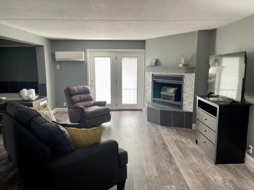 a living room with a couch and a chair at Lake Norfork Resort in Henderson