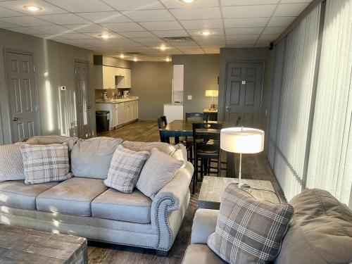 a living room with two couches and a dining room at Lake Norfork Resort in Henderson
