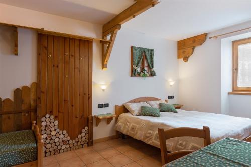 a bedroom with a bed and a wooden wall at AL BORGO ANTICO residenza in Pinzolo