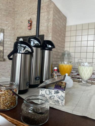 a counter with two kettles on top of a kitchen counter at Pousada Casa Mariscal in Bombinhas