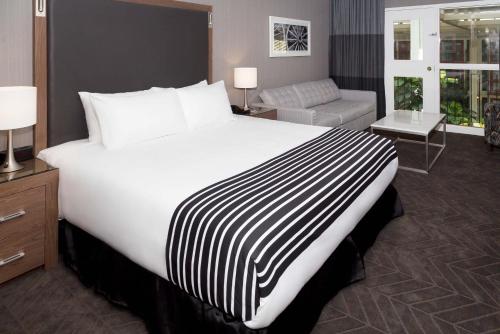 a large white bed in a hotel room at Sandman Signature Lethbridge Lodge in Lethbridge