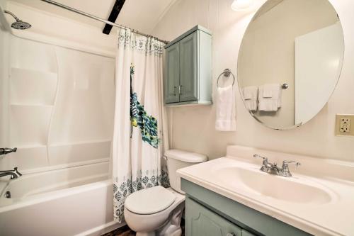 a bathroom with a sink and a toilet and a mirror at Carmine Cottage with Porch on Beautiful 60-Acre Farm in Carmine