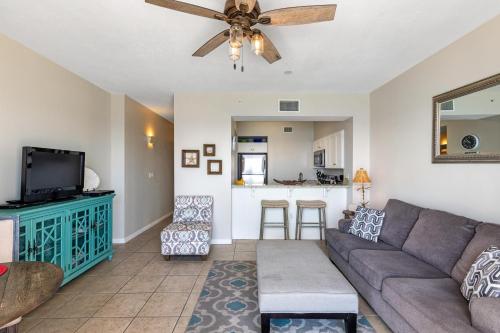 a living room with a couch and a ceiling fan at Windemere 904 Pool Side Cabana Included! in Perdido Key