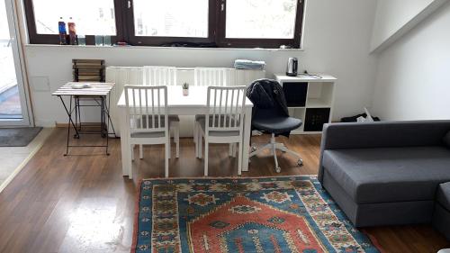 a living room with a table and chairs and a couch at Leon Duren in Düren - Eifel