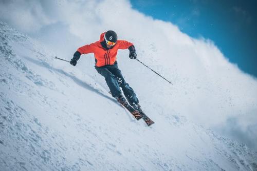 a man is skiing down a snow covered slope at Chalet Schwarz in Berwang