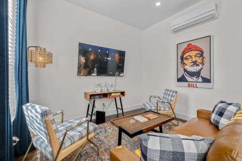 a living room with a couch and chairs and a table at The Murray in Bentonville