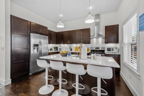 a kitchen with a large island with bar stools at The Murray in Bentonville