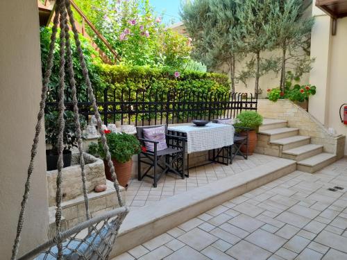 a patio with a table and chairs and a fence at Calergi Residence - Holidays in Crete in Atsipopoulo