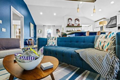 a living room with a blue couch and a table at The Sinatra in Bentonville