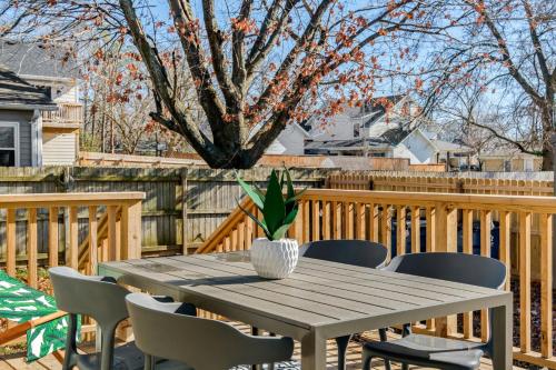 a wooden table and chairs on a deck at The Sinatra in Bentonville