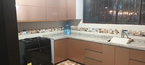 a kitchen with a bottle of water sitting on a counter at Hospedaje Casona Villa Alicia in Los Santos