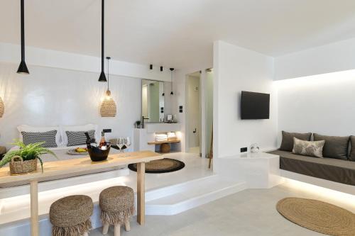 a living room with a table and a couch at Ios Art Studios & Luxury Apartments in Ios Chora