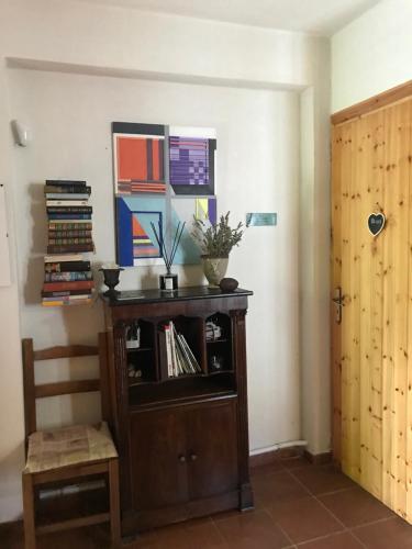 a room with a wooden book shelf with books at Casa Marida in Camigliatello Silano
