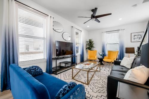 a living room with a blue couch and chairs at The Hub in Fayetteville
