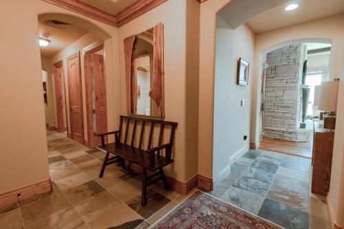 a hallway with a rocking chair in a house at Silver Strike Condo by Lespri Property Management in Park City