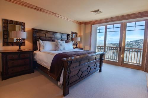 a bedroom with a large bed and a balcony at Silver Strike Condo by Lespri Property Management in Park City