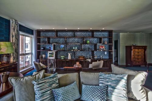 a living room with a couch with pillows at Oscar Chalupsky Apartment in Vila do Conde