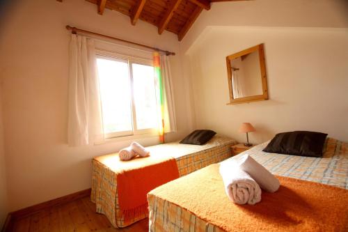 a bedroom with two beds and a window at Alonia Villas in Pissouri