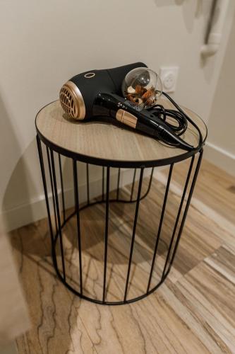 a table with a hair dryer on top of it at UM studios - Charmants studios tout équipé - wifi in Saint-Chamond