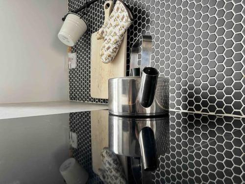 a kitchen with a black and white patterned wall at Le Charismatique in Nantes