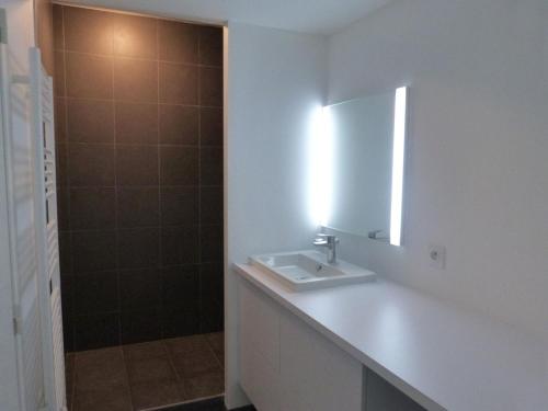 a bathroom with a sink and a mirror and a shower at Appartement 2 chambres, balcon, accès plage, piscine, parking, animaux admis - La Tranche-sur-Mer - FR-1-194-232 in La Tranche-sur-Mer