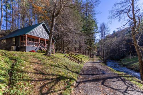 a house on a hill next to a river at Hidden Cabin on Old Field Creek in Fleetwood
