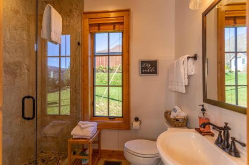 a bathroom with a tub and a toilet and a sink at Banner Sky in Banner Elk