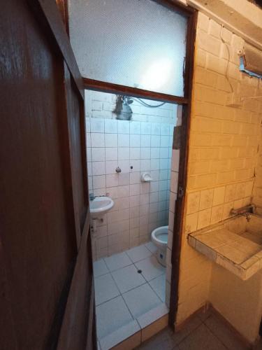a small bathroom with a toilet and a sink at LOFT CENTRO DE AREQUIPA in Arequipa