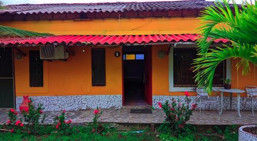 a colorful house with a red roof at Playa Mar Sun Caribe in Turbo