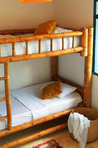 a bedroom with two bunk beds in a room at Casa Mostaza-Ecolodge in Samaná