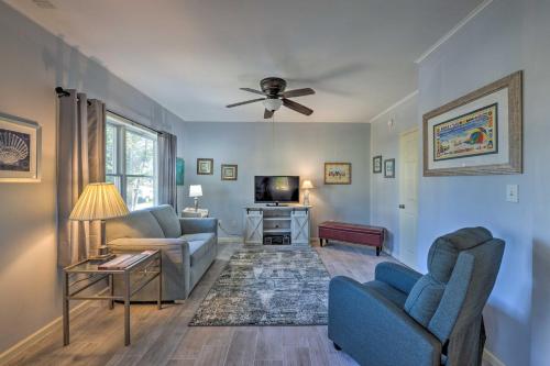 a living room with two chairs and a tv at Serene West Cape May Getaway Walk to Beach! in Cape May