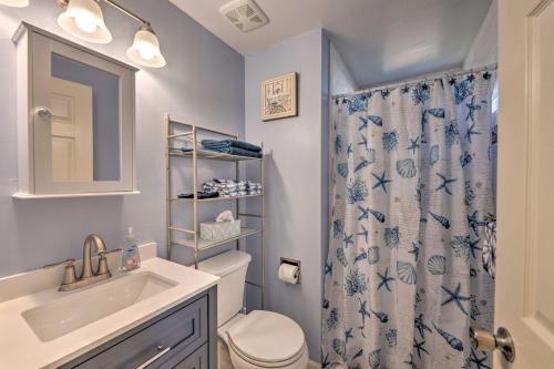 a bathroom with a toilet and a shower curtain at Serene West Cape May Getaway Walk to Beach! in Cape May