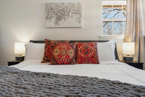 a bedroom with a white bed with pillows and a window at The Torino in Bentonville