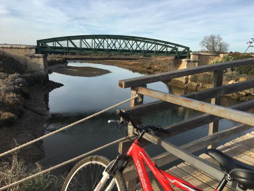 a bike parked on a bridge over a river at Golden Club- Eyes on Sea in Cabanas de Tavira