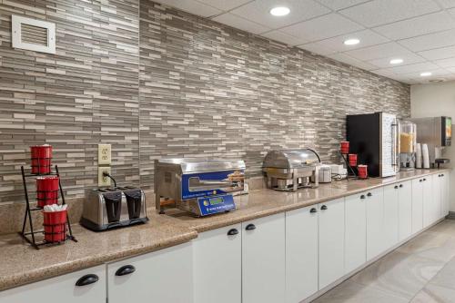 a kitchen with a counter with a toaster and appliances at Best Western PLUS Executive Hotel Richmond in Richmond