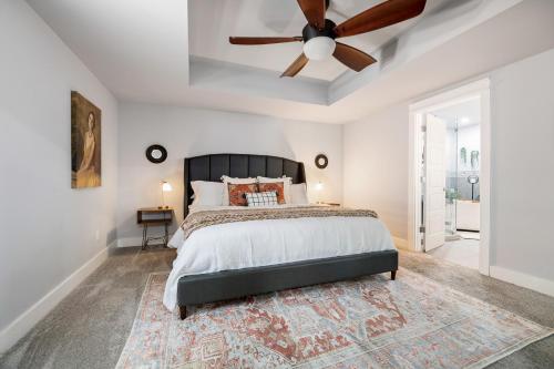 a bedroom with a bed and a ceiling fan at The Sam in Bentonville