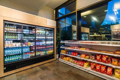 a grocery store aisle with a large selection of drinks at Park Inn by Radisson Stuttgart in Stuttgart